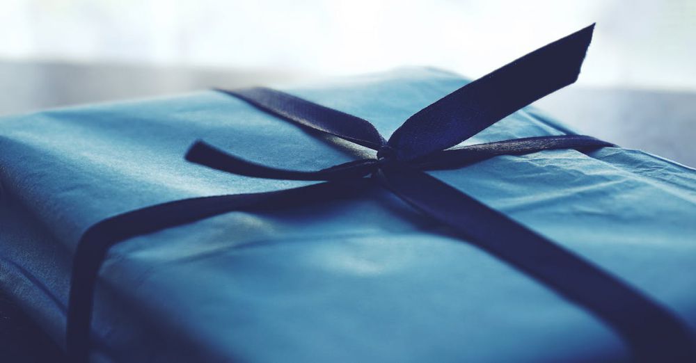 Gift Wrap - A close-up of a beautifully wrapped blue gift box with a ribbon, perfect for special occasions.