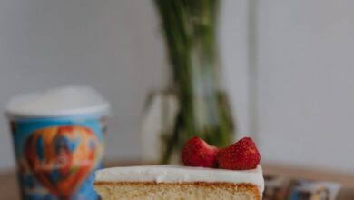 Dish Sponges - A slice of strawberry layered cake on a plate with daisies in the background, ideal for dessert themes.