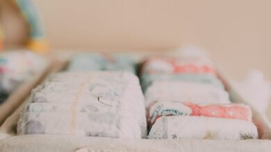 Cloth Diapers - Close-up of a woven basket with neatly arranged baby diapers in a neutral-toned nursery.