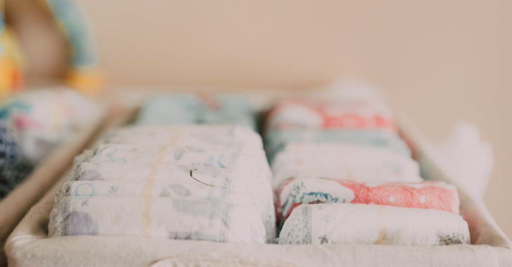 Cloth Diapers - Close-up of a woven basket with neatly arranged baby diapers in a neutral-toned nursery.