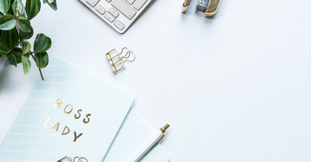 Stapler - Elegant workspace featuring a 'Boss Lady' notebook, plant, and office supplies on a white background.