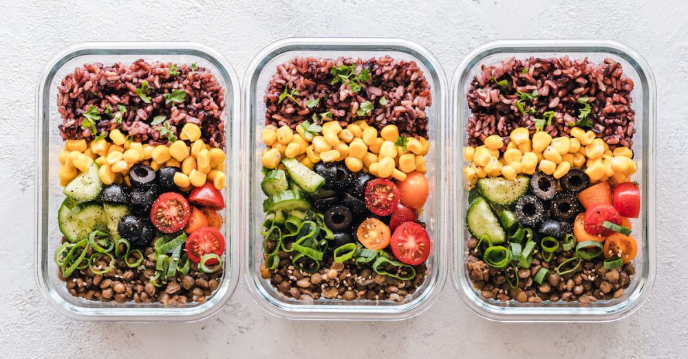 Prep Containers - Colorful healthy meal prep with corn, olives, tomatoes, and lentils in glass containers. Perfect for mindful eating.