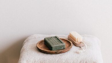 Paperless Towels - Elegant stacked towels with soap and brush create a calming bathroom vibe.