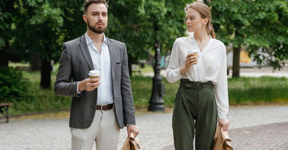 Lunch Bags - A man and woman stroll through a park with coffee and lunch bags in hand.