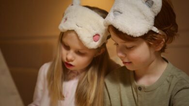 Sleep Masks - Two cute children wearing fluffy sleep masks, bonding during bedtime indoors. Perfect for family themed content.