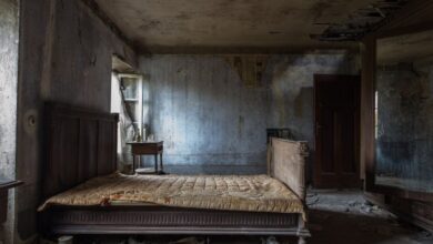 Mattress Protectors - Explore the haunting beauty of an abandoned rustic bedroom, displaying decayed furniture and peeling walls.
