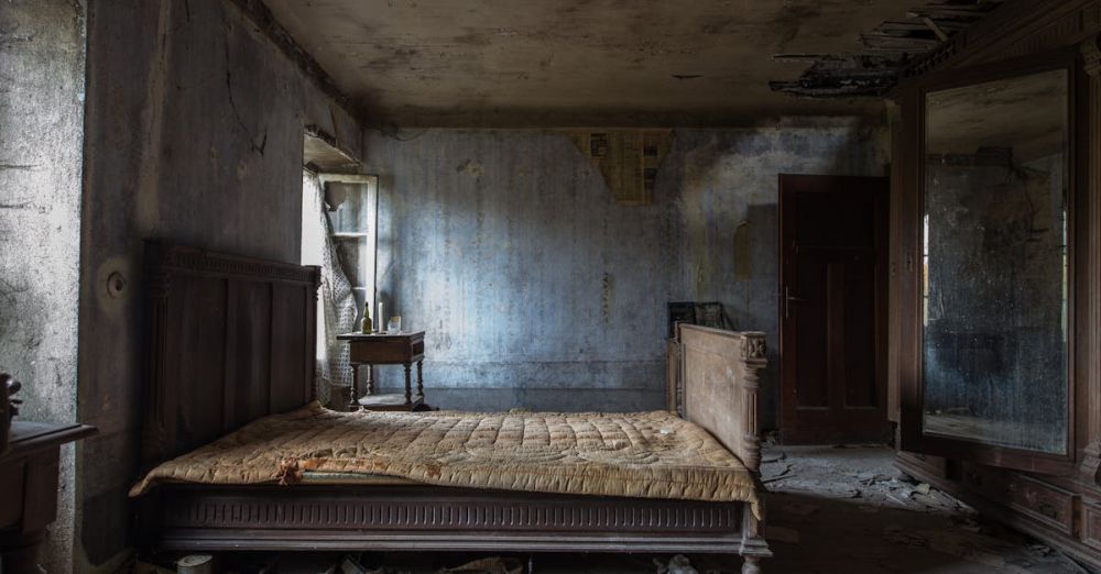 Mattress Protectors - Explore the haunting beauty of an abandoned rustic bedroom, displaying decayed furniture and peeling walls.