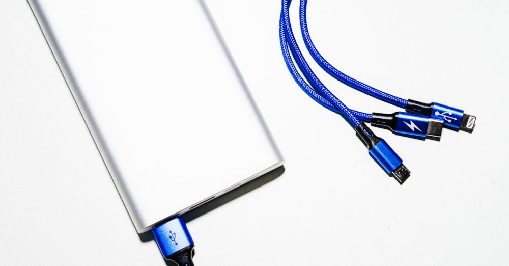 Phone Chargers - Minimalist image of a power bank with blue USB charging cables on a white background.