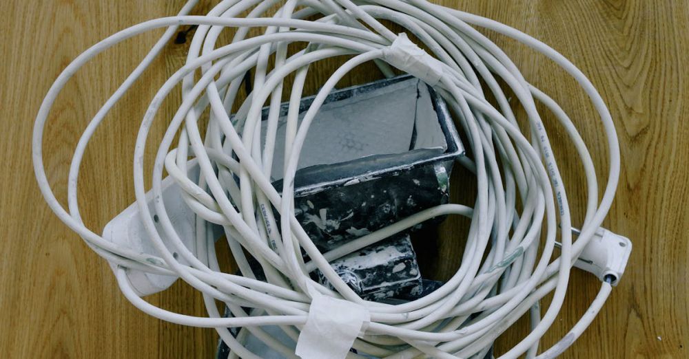 Power Strips - Top view of electrical white cord with standard electrical plug power outlet placed on spotlight on wooden surface during repair