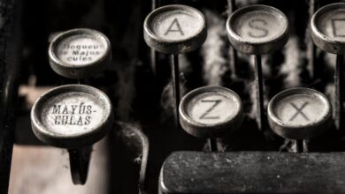 Keyboards - Detailed close-up of vintage typewriter keys showing dust and age.