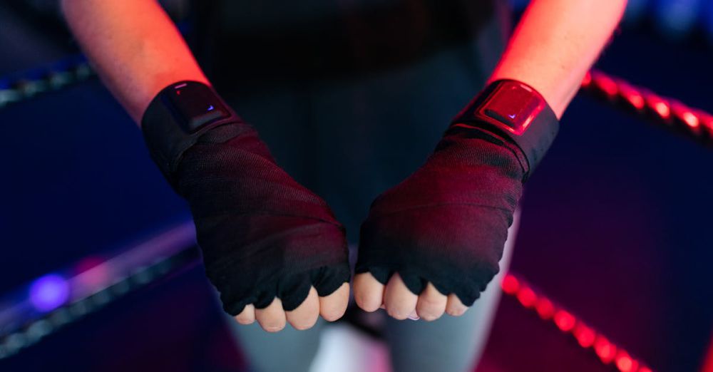 Tracking Devices - Female boxer wearing smart gloves in a gym, showcasing fitness and technology integration.