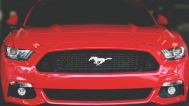 Headlamps - Bright red Ford Mustang showcased with a sleek front view in Ahmedabad.