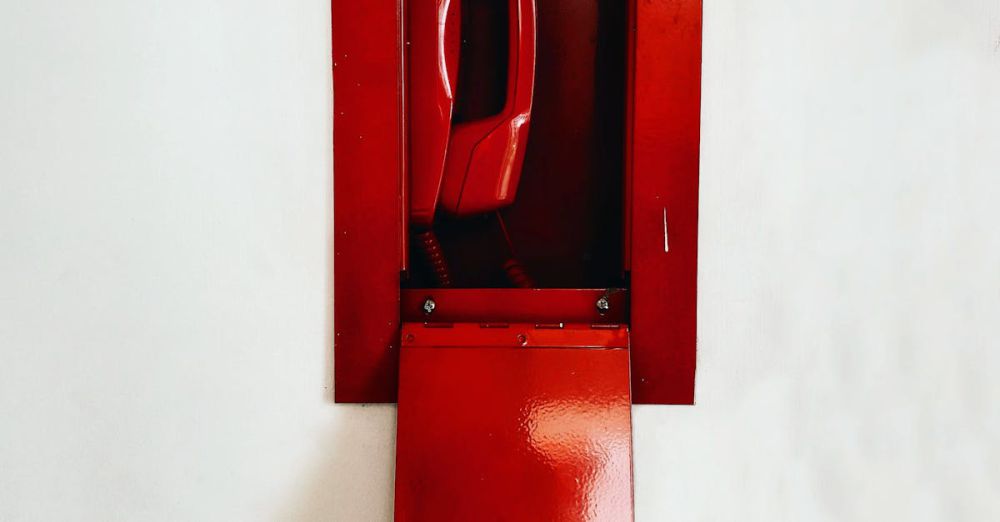 Phone Mounts - Classic red emergency wall telephone with open panel, showcasing retro design.