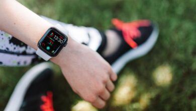 Fitness Apps - Close-up of a smartwatch on a woman's wrist during outdoor fitness activity.