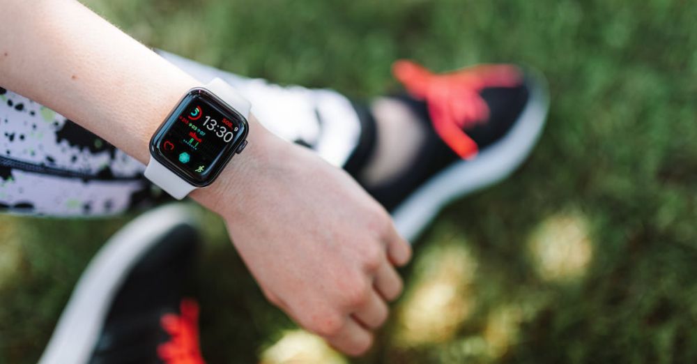 Fitness Apps - Close-up of a smartwatch on a woman's wrist during outdoor fitness activity.