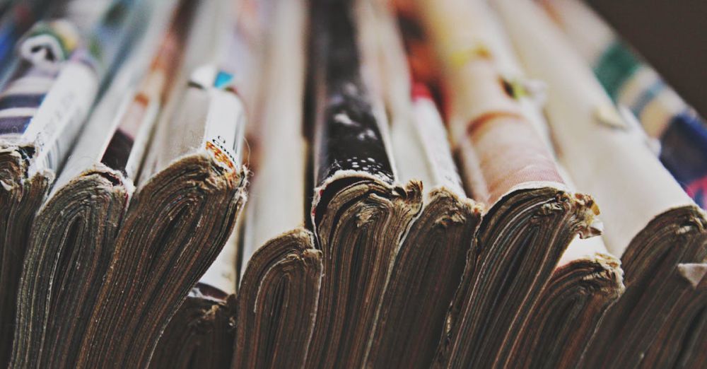 Magazine Subscriptions - A detailed close-up image of a stack of magazines arranged in a row, showcasing their bindings.