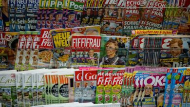 News Subscriptions - A vibrant display of magazines in a newsstand, showcasing various colorful covers and headlines.