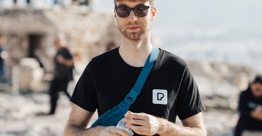 Sports Subscriptions - A man in a black shirt and sunglasses standing on a rock