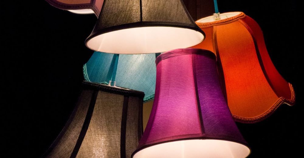 Lamps - A bold display of colorful lampshades creating an artistic light fixture indoors.