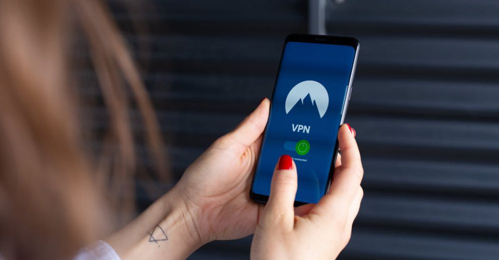 VPN Services - Close-up of a woman's hands using a VPN app on a smartphone, emphasizing digital security.