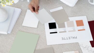 Small Business Plans - Designer sits on carpet with color palettes and samples, planning creative project.