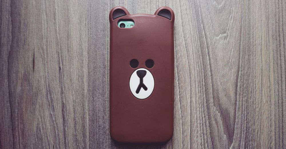 Phone Cases - Cute bear phone case resting on a rustic wooden table, ideal for tech and lifestyle themes.