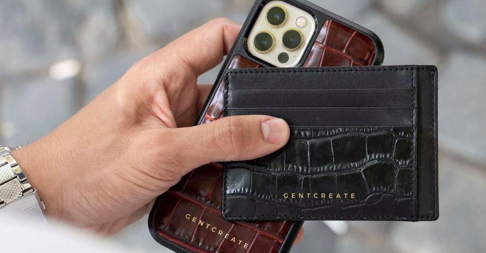 Phone Holders - Person holding an iPhone with a black leather card holder on a paved street.