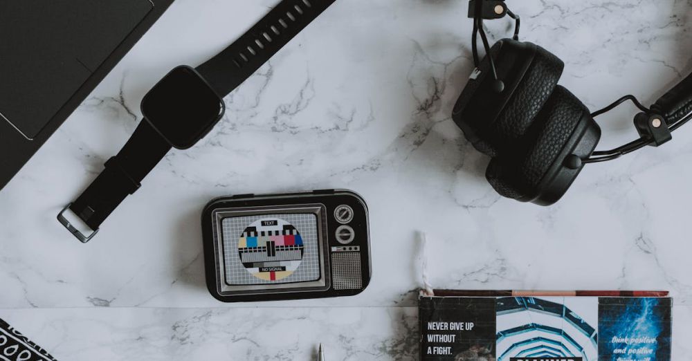 Smartwatch Bands - A flat lay composition of digital devices and a vintage camera on a marble surface.