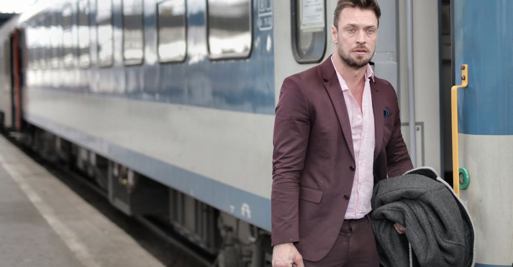 Docking Stations - Man in suit exiting a passenger train, holding a coat and bag.