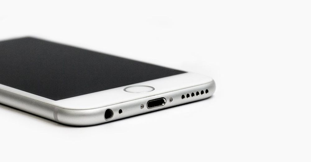 Wireless Chargers - Minimalist image of a sleek smartphone with focus on the bottom edge and ports.