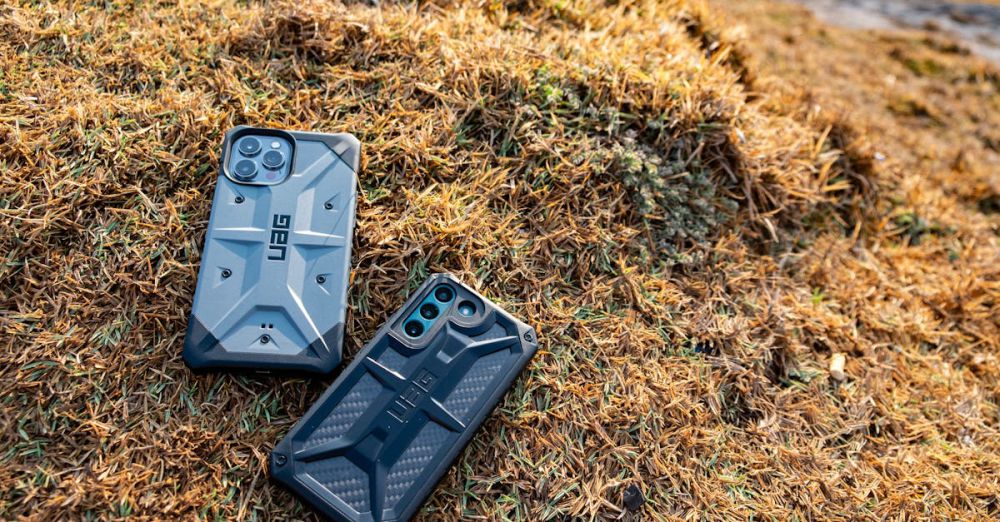 Rugged Cases - Two rugged smartphones with protective cases on dried grass, Phan Thiet, Vietnam.