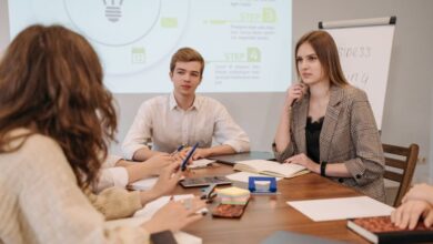 Smartphone Projectors - A group of young professionals in a modern office setting discussing ideas during a meeting.