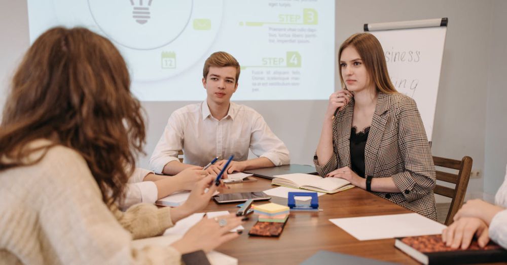 Smartphone Projectors - A group of young professionals in a modern office setting discussing ideas during a meeting.