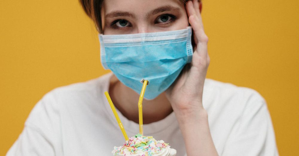 Face Masks - Woman wearing mask sipping milkshake with straws - humorous take on safety.