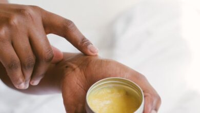 Body Lotions - Close-up of a hand applying natural skincare cream, emphasizing self-care and holistic health.