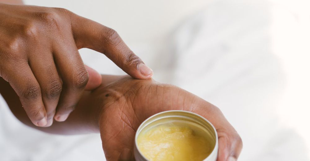 Body Lotions - Close-up of a hand applying natural skincare cream, emphasizing self-care and holistic health.