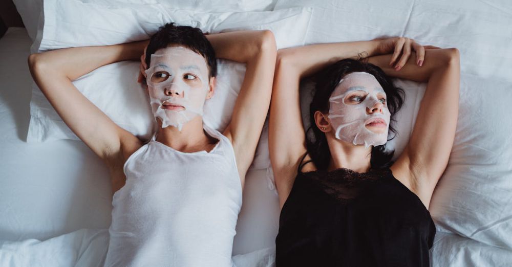 Sheet Masks - Two women enjoy a soothing relaxation with sheet masks, lying together in a comfortable setting.