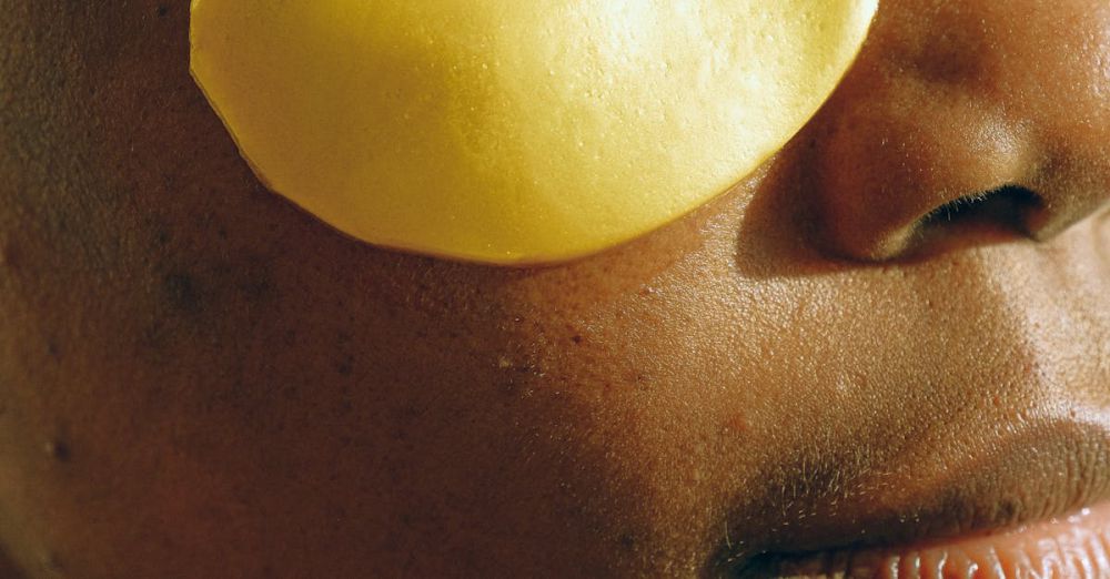 Collagen Boosters - Close-up of a woman applying gold under-eye patches for skincare treatment.