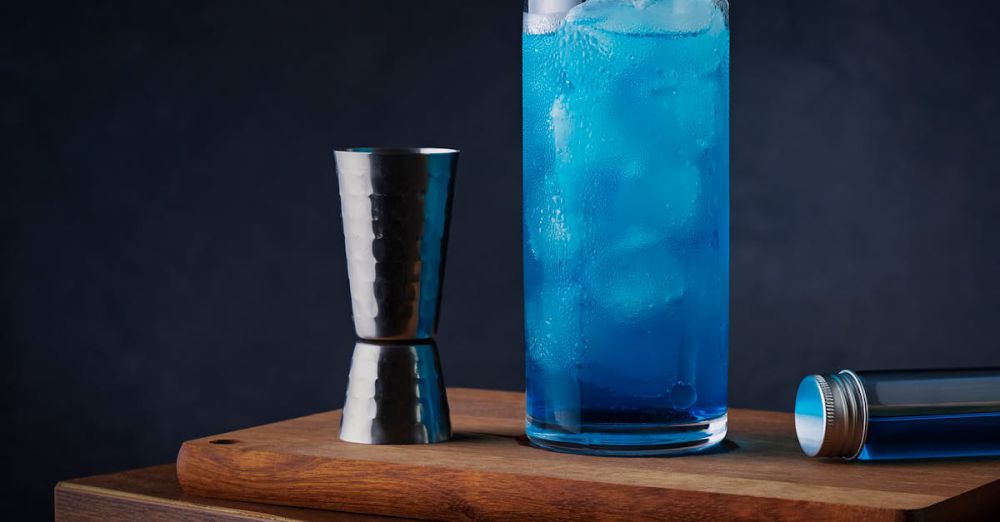 Multi-Tools - A blue drink with a shot glass on a wooden table