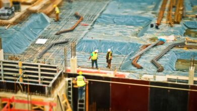 Ladders - High-angle view of construction workers on a building site, engaging in construction work.