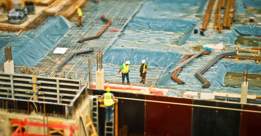 Ladders - High-angle view of construction workers on a building site, engaging in construction work.