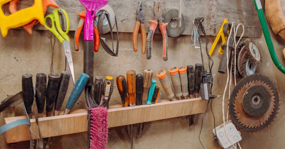 Utility Knives - Organized hand tools on wall in a workshop. Essential carpentry equipment neatly displayed.