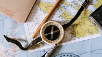 Measuring Tools - Flat lay of vintage compass, protractor, and maps for navigation study.