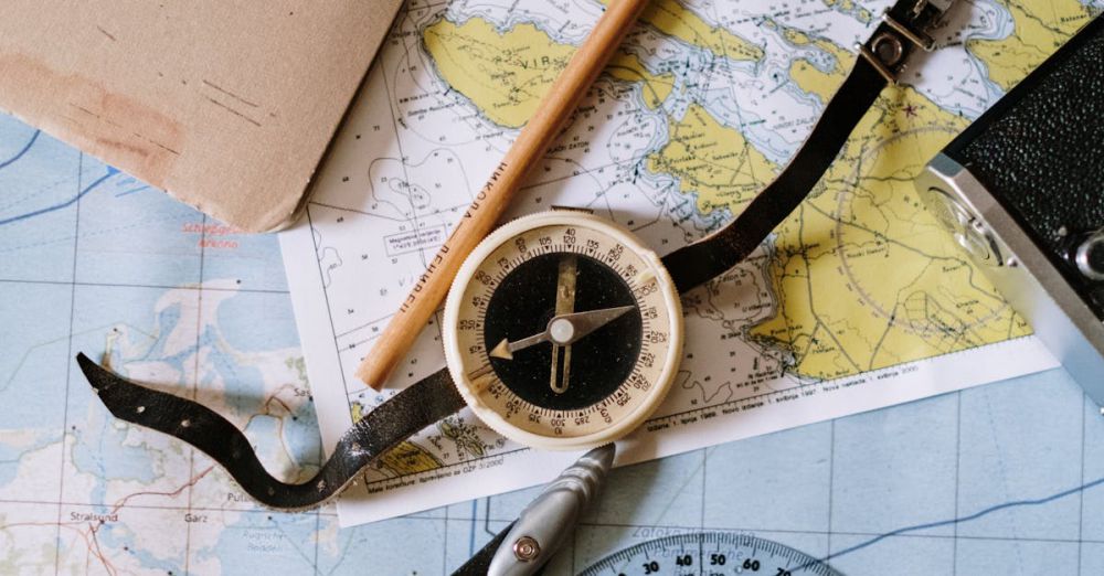 Measuring Tools - Flat lay of vintage compass, protractor, and maps for navigation study.