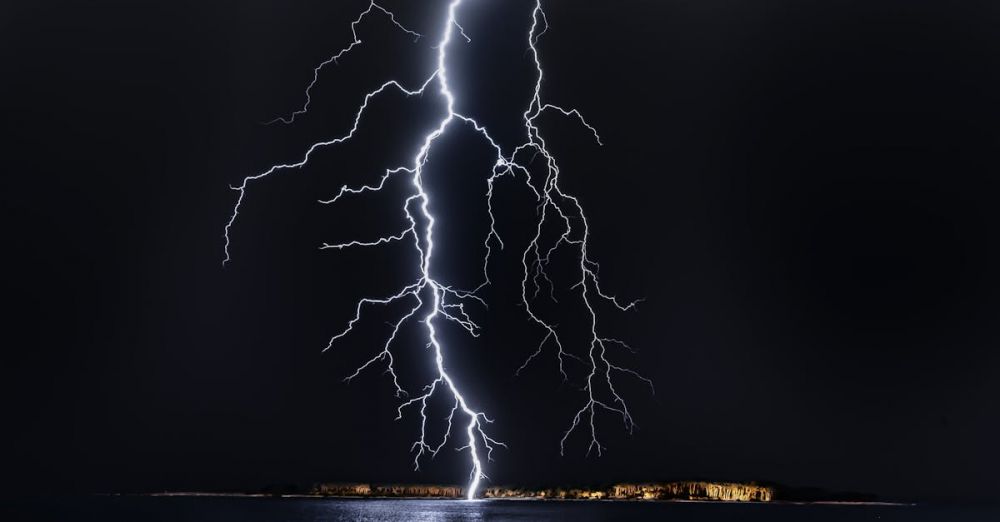 Bolt Cutters - Dramatic lightning bolt over the ocean at night, illuminating the coastal landscape.