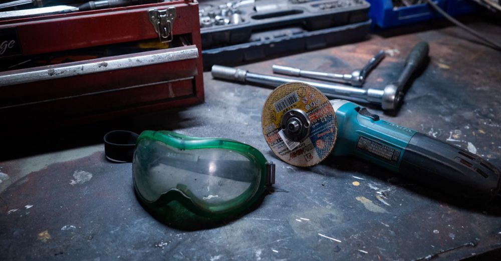 Toolboxes - A workshop scene with tools, a grinder, and safety goggles on a workbench.