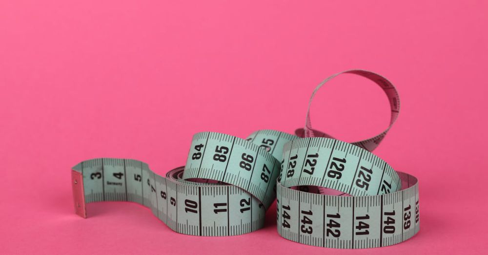 Tool Kits - Focus on a curled measuring tape against a vibrant pink backdrop.