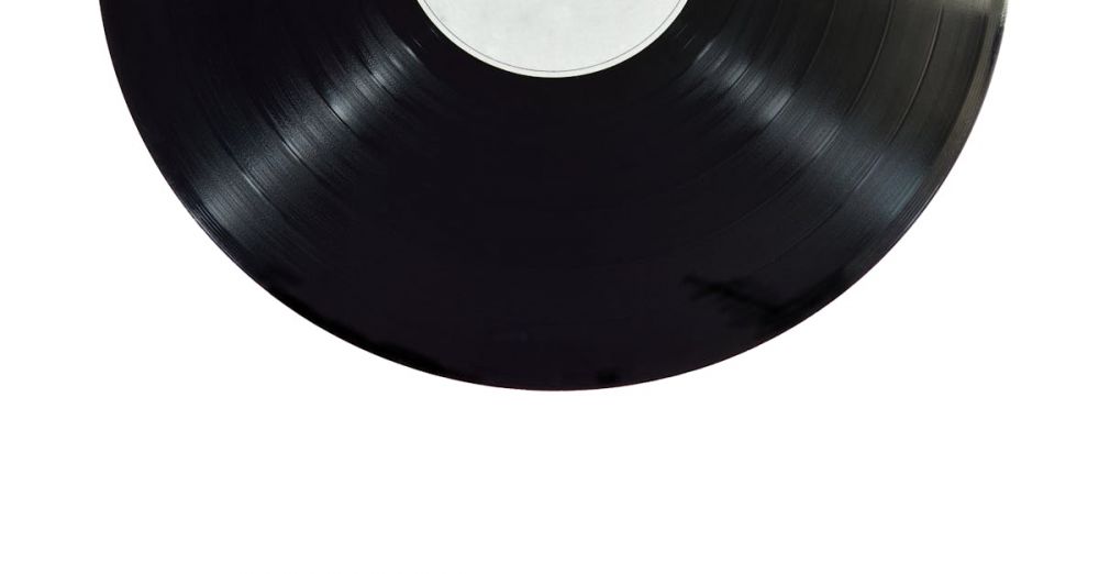 Vinyl Records - A classic black vinyl record isolated on a white background.