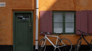 Vintage Bicycles - A vibrant street scene in Kjellerup, Denmark, featuring colorful house facades and parked bicycles.