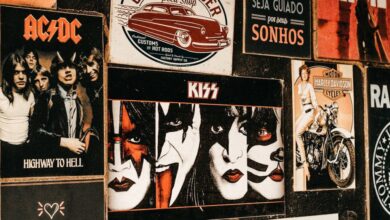 Posters - A collage of iconic rock band posters and vintage advertisements on a textured wall.